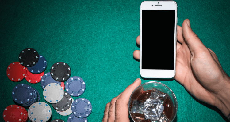 an image of a mobile phone along with the gambling coins representing practices of responsible gaming in casino online