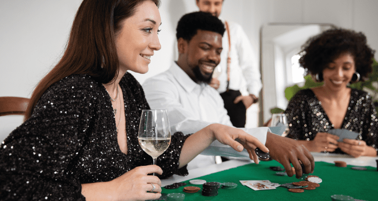 Friends are playing cards in a casino in happy mood representing safe play of gambling